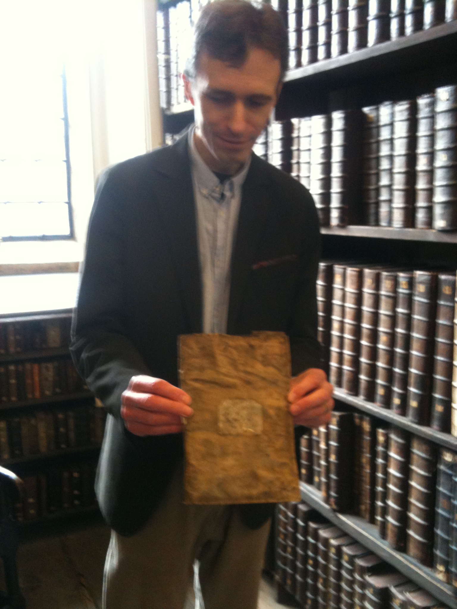 Queens' College Old Library. Tim Eggington showing the Andrew Docket's inventory of the chained library from 1472