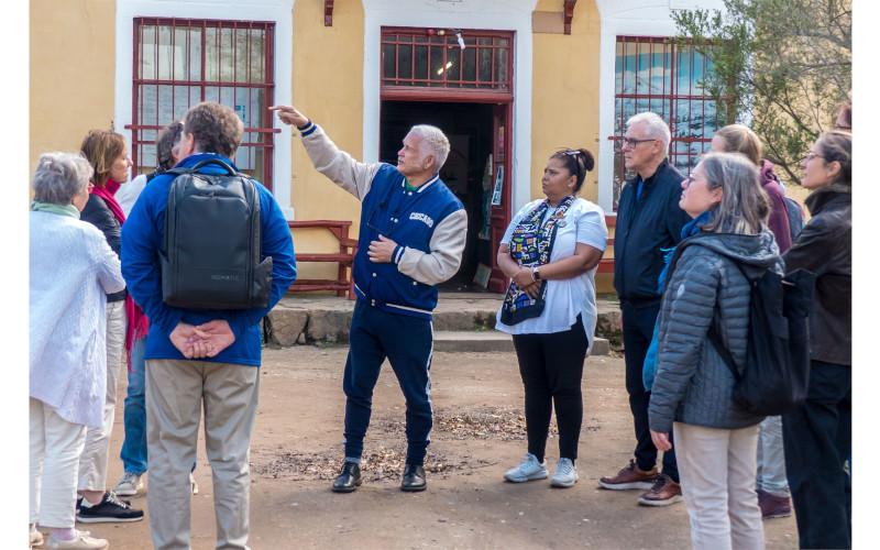 Dr Isaac Balie guiding the tour of the historical village | Photograph © Jürgen May